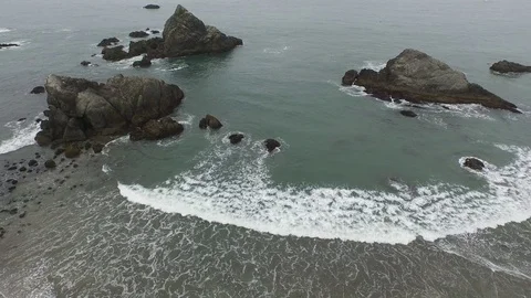 Aerial View Looking Down On Rock Formations on Ocean Shore Stock Footage 71164342