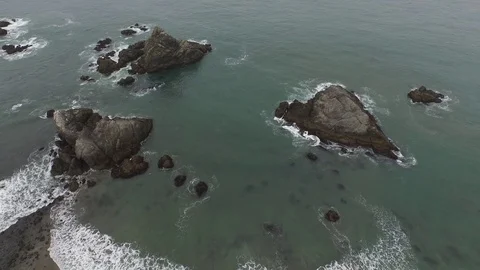 Aerial View Looking Down On Rock Formations on Ocean Shore 스톡 동영상 71164784