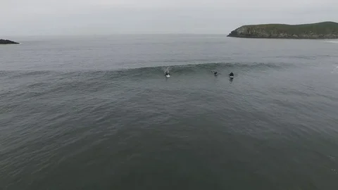 Aerial view looking down on three surfers. Surfing on the oregon coast. Stock Footage 70401088