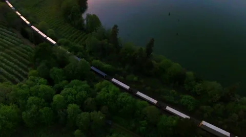 Aerial view looking down on a train traveling through an orchard. Stock Footage 68797540