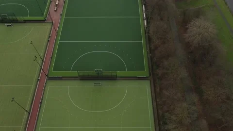 Aerial view looking over multiple green sport fields with white dugouts Stock Footage 142751432