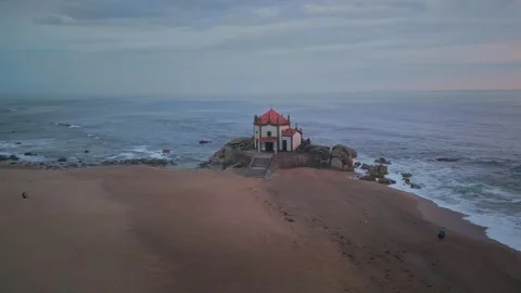 Aerial view of Lord of the Rock chapel at sunset (Capela do Senhor da Pedra) Stock Footage 242512931