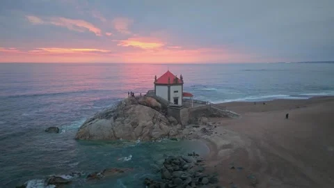 Aerial view of Lord of the Rock chapel at sunset (Capela do Senhor da Pedra) Stock Footage 242512932