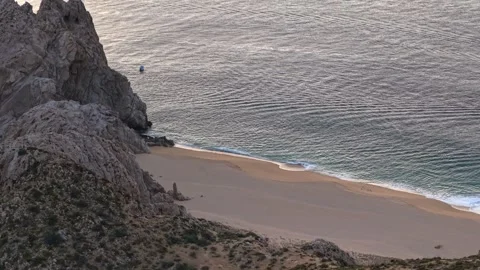 Aerial view of Lovers' Beach in Cabo San Lucas at sunset, a secluded beach in Stock Footage 334833141
