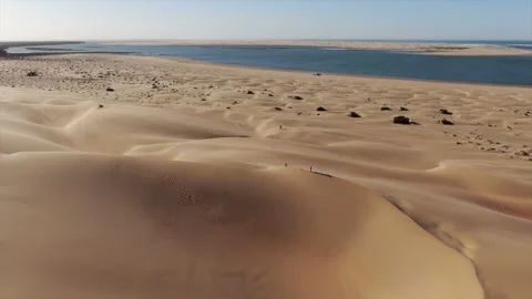 Aerial view low altitude and over the dunes that are in the Naila Stock Footage 245585162