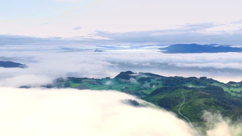 Aerial View of Low Clouds Rolling Over Norwegian Hills Stock Footage 319987038