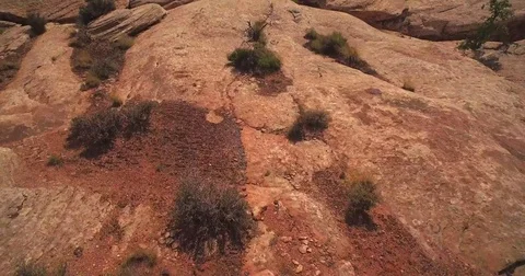 Aerial view low over rocks to reveal a canyon. Canyonlands National Park. Utah Stock Footage 77818935