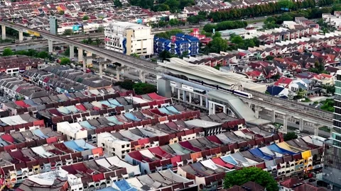 Aerial view of LRT moving through Subang SS15 in daytime Vídeo Stock 332157380