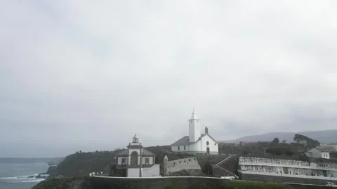 Aerial view of Luarca lighthouse and church against sea Stock Footage 274084509