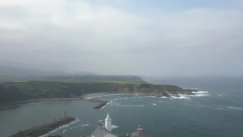 Aerial view of Luarca lighthouse and church against sea Stock Footage 274084592