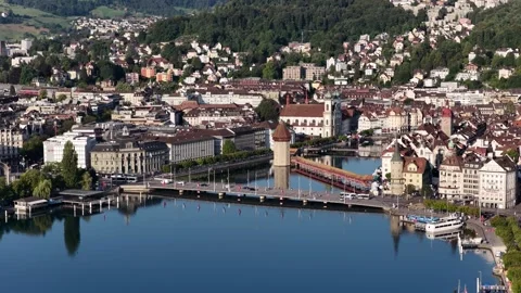 Aerial view of Lucerne waterfront with the iconic Chapel Bridge and Wasserturm Stock Footage 345311174
