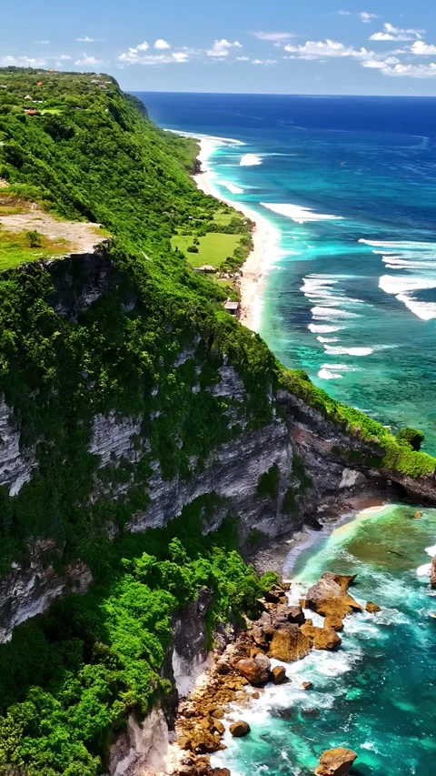 Aerial view of lush cliffs and turquoise ocean in Bali, Indonesia. Stock Footage 340776818