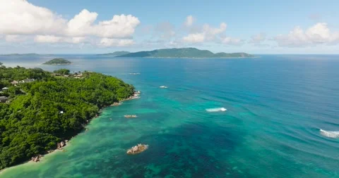 Aerial view of lush coastline and turquoise waters. Praslin, Seychelles. Stock Footage 302772353