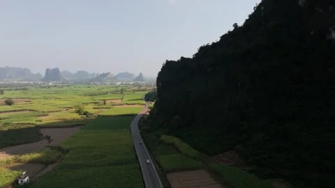 Aerial View of Lush Green Fields and Karst Mountains in Guangxi, China Video stock 336711335