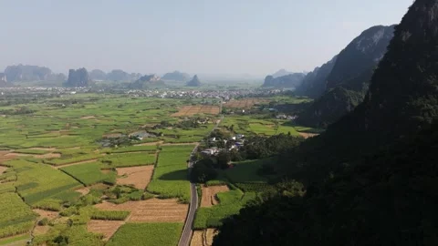 Aerial View of Lush Green Fields and Karst Mountains in Guangxi, China Vídeos de archivo 336711342