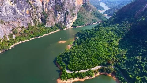 Aerial View Lush Green Forest and Steep Cliffs Along Winding River China Stock Footage 339639030