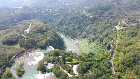 Aerial View of Lush Green Forest Surrounding a Large Waterfall in a Scenic Park Stock Footage 341944648