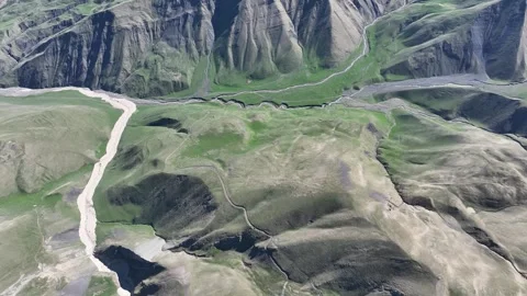 Aerial View of a Lush Green Mountain Valley with River and Roads Stock Footage 341882575