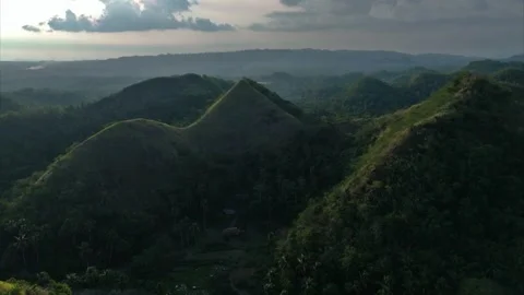 Aerial view of lush, undulating Quitinday green hills under a cloudy sky Stock Footage 337252238