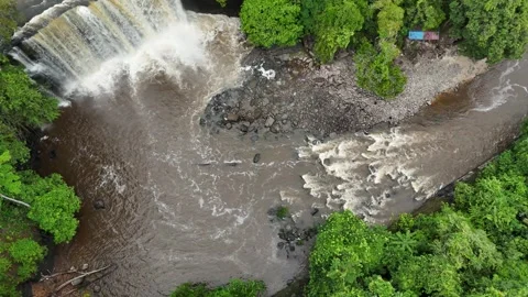 Aerial view of a lush waterfall cascading through dense green forest. Stock Footage 337991589
