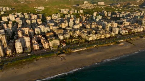Aerial View: A luxurious villa complex on the seafront boasts a sparkling pool Stock Footage 296036586