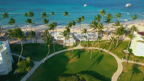 Aerial view of luxury residence sunset, turquoise ocean, sandy beach, palm trees Video stock 308334479