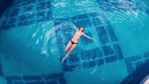 Aerial view of lying on water surface in big swimming pool 動画素材 102377888