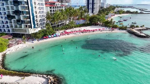 Aerial View of Maafushi Beach with Red Umbrellas Maldives Tropical Coastline Vídeo Stock 332632946