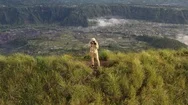 Aerial View Of Man With A Camera On Top Of A Cliff Overlooking The Mountains Stock Footage