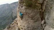 Aerial View Of Man Climbing A Stone Mountain With Safe Equipment. Stock Footage