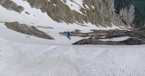 Aerial view- A Man Does A Jump While Skiing In The Mountains Stock Footage 252728535