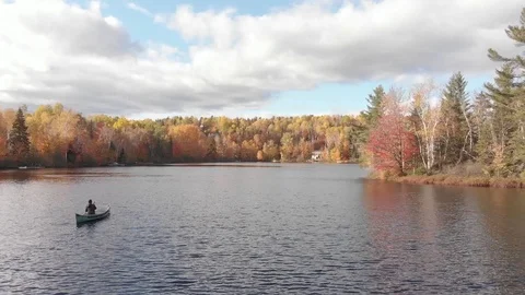 Aerial view of man doing canoe on a lake in Quebec during autumn season Stock Footage 104374518