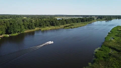 Aerial view of man enjoying jet ski river ride on sunny summer day. Stock Footage