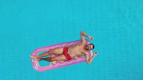 Aerial View Of Man Floating On Inflatable Mattress, Relaxing. Stock Footage 121251839