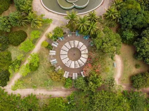 Aerial view of man inside circular playground and pond in park in Barra da ti Stock Photos