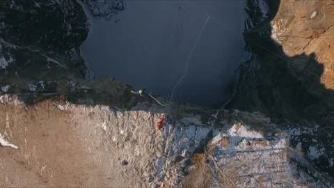Aerial view of a man jumping off a cliff. Rope jumping. Stock Footage 87916994