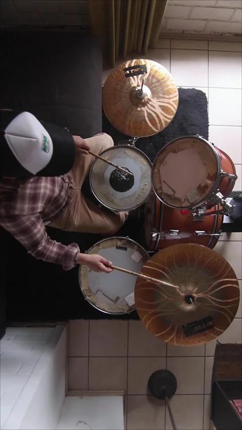 Aerial view of a man playing and practicing the drums Stock Footage 345082061