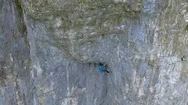 Aerial View Of A Man Rock Climbing Up A Mountain. Stock Footage