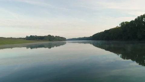 Aerial view of a man rowing in a boat in the middle of a river. Stock Footage 134699994