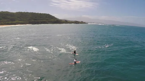 Aerial view of a man sitting while sup stand-up paddleboard surfing in Hawaii, s 스톡 동영상 68595283