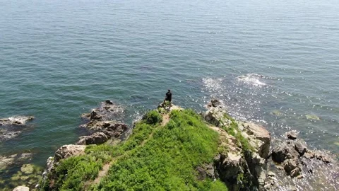 Aerial view of man standing on cliff in front of Ocean, Primorsky Krai, Russia Stock Footage 315207802