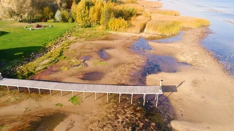 Aerial view of man standing on the edge of wood pier, Estonia. Stock Footage 101572266