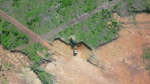 Aerial view of a man standing on top of a dirt hill 스톡 동영상 330760258