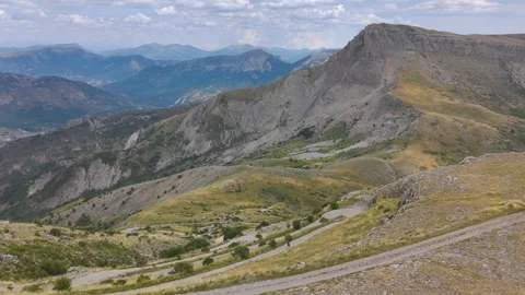 Aerial View of Man Walking Alone Through Mountains Stock Footage 338006692