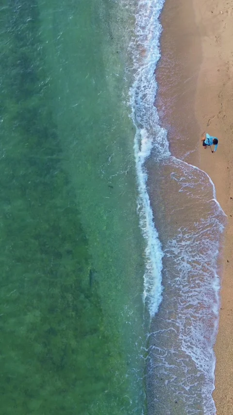 Aerial view of a man walking on the beach Video stock 300360623