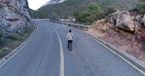 Aerial view of a man walking on the road Stock Footage 102851903