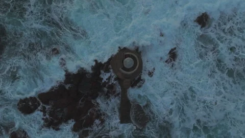 Aerial view of the Mangiabarche Lighthouse, hit by waves at sunset Stock Footage 313291114