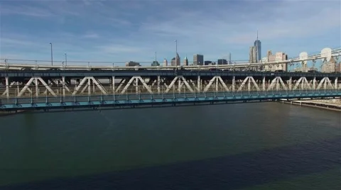 Aerial view of Manhattan Bridge. Camera moves upwards from the bridge level. Stock Footage 58566783