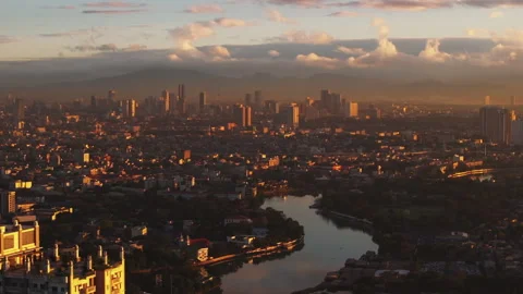 Aerial view of Manila at sunset, capturing the city's skyline and river against Stock Footage 276519581