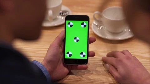 Aerial view of man’s hand sliding the greenscreen of the phone Stock Footage 73753078